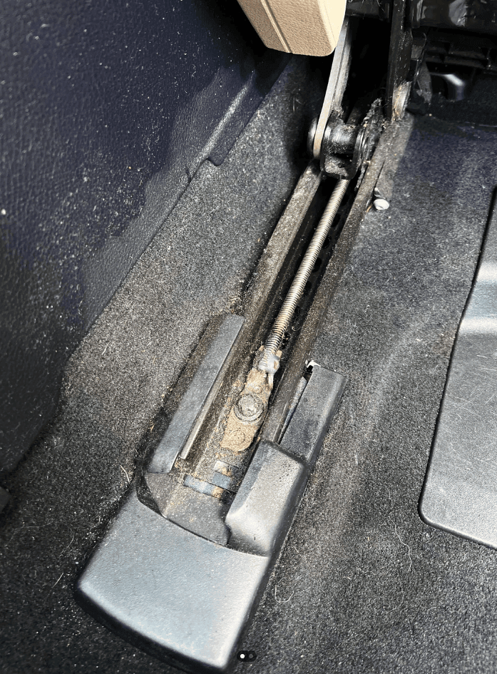 Close-up of car seat tracks and debris where flea eggs and larvae concentrate.