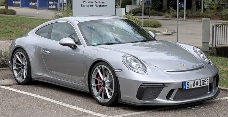 Silver Porsche 911 GT3 parked in a lot near a dealership. pic for the page, how do i get rid of roaches in my car
